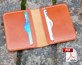 May include: A brown leather wallet with two card slots. The wallet is open and shows the inside, which is a light brown color. The wallet is sitting on a brick surface.