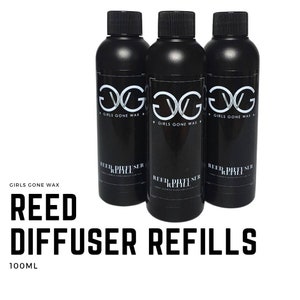 May include: Three black bottles with white labels that say "Girls Gone Wax" and "Reed Diffuser Refill" with a white logo. The bottles are 100 ml each.