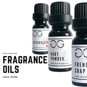 May include: Three small glass bottles with black caps and white labels. The labels feature the text "Girls Gone Wax" and the names of the scents: "Seychelles", "Baby Powder", and "French Soap". The bottles are labelled as "Pure Fragrance Oil" and are 100% pure.