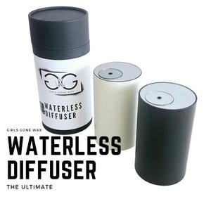 May include: Three black and white waterless diffusers. The largest diffuser has the text "Girls Gone Wax" and "Waterless Diffuser" printed on it. The text "The Ultimate" is printed below the image of the diffusers.
