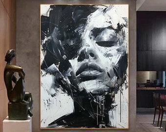May include: Black and white abstract painting of a woman's face. The painting is done in a bold, expressive style with thick brushstrokes. The woman's eyes are closed and her lips are slightly parted. The background is a white canvas with black accents.