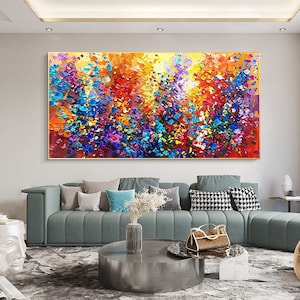 May include: Abstract painting with a colorful, textured, and vibrant design. The painting features a mix of blue, purple, yellow, orange, red, and green colors. The painting is framed in a gold frame.