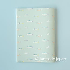 May include: A notebook with a light green cover featuring a repeating pattern of colorful fish illustrations. The fish are in shades of blue, yellow, and orange. The text "&copy; fantastic japan" is printed at the bottom.