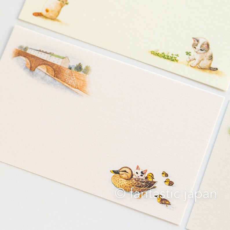 May include: Stationery set featuring illustrations of a bridge, a duck with ducklings, and kittens. The stationery has a cream-colored background with the illustrations in soft watercolor tones. The image includes the text "&copy; fantastic japan".