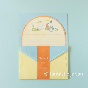 May include: A stationery set featuring a light blue envelope with a yellow interior. The set includes a card with illustrations of rabbits and flowers. The envelope has a decorative orange band with the text "My mood" and a quote.