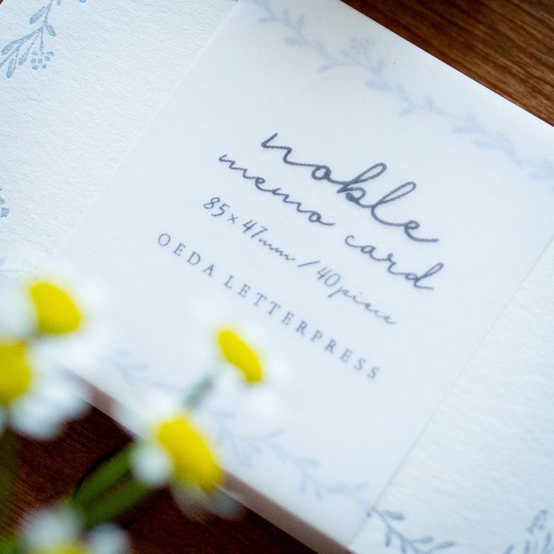 May include: A pack of white memo cards with a floral design and the text "remarkable memo card 85 x 47mm / 40 piece OEDA LETTERPRESS" printed in gray.