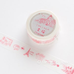 May include: A roll of pink and white washi tape with a design of a church and trees. The tape has the text "[france]" and Japanese characters on it.