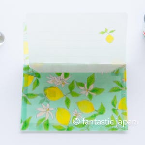 May include: A stationery set featuring a light green envelope with a watercolor design of yellow lemons, white blossoms, and green leaves. The text "fantastic japan" is visible on the envelope.