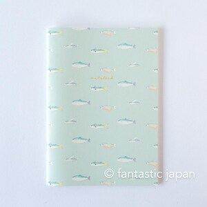 May include: A notebook with a light green cover featuring a pattern of various fish in shades of blue, orange, and gray. The word "waterlili" is written in cursive. The text "fantastic japan" is at the bottom.
