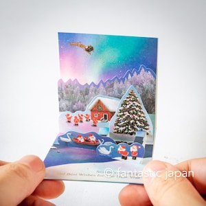 Pequeno cartão pop-up de Natal - mini mini Papais Noéis aurora no céu -