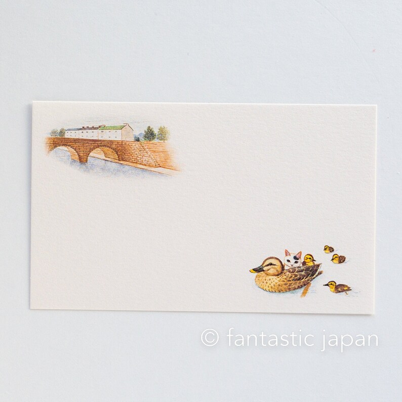May include: Cream-colored stationery card with watercolor illustrations. Features a bridge over water and a duck with kittens and ducklings. The text "fantastic japan" is at the bottom.
