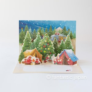May include: A pop-up Christmas card featuring a winter camping scene with decorated Christmas trees, tents, and a camper. The card has a snowy night sky background and includes the text "fantastic japan".