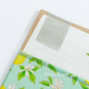 May include: A mini letter set with a clear plastic cover. The set includes 6 papers, 3 envelopes, and 3 stickers. The cover has a label that says "Clair". The bottom of the set has a light green floral design with lemons and white flowers.