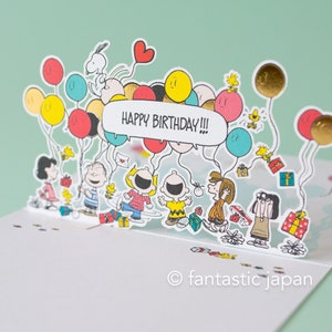 Tarjeta desplegable de cumpleaños de Hallmark / PEANUTS (muchos globos)