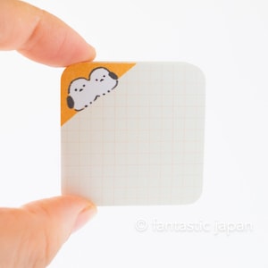 Może przedstawiać: Biały notes z siatką i żółtym rogiem z czarno-białym rysunkiem dwóch ptaków.