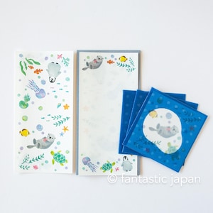 May include: Stationery set featuring marine life illustrations. The set includes a long notepad, a smaller notepad, and blue square notepads. The designs feature seals, jellyfish, turtles, and fish in a whimsical underwater scene. The text "fantastic japan" is visible.