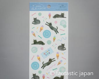 Puede incluir: Una hoja de pegatinas con gatos negros, conos de helado y remolinos coloridos sobre un fondo azul claro. El texto "Good Day" aparece en una de las pegatinas. Las pegatinas son de la marca "awairo".