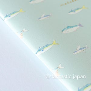 May include: A light blue paper with a repeating pattern of watercolor fish in shades of blue, yellow, and white. The fish are swimming in various directions. The text "&copy; fantastic japan" is in the bottom right corner.