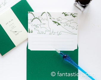 May include: A set of green stationery featuring a dinosaur illustration. The set includes 6 sheets of paper and 3 envelopes. The text on the paper reads "Oh la la! Letterpress 6 papers 3 envelopes"