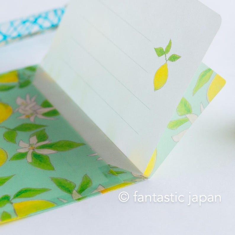 May include: A notepad with a lemon theme. The pages are lined and feature a small lemon illustration. The cover has a light green background with lemon and flower designs. The text "fantastic japan" is visible.
