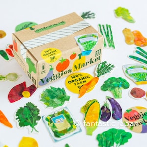 Flocons d'autocollants hologrammes découpés dans une petite boîte de livraison -légumes-