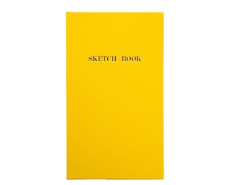 May include: A yellow sketchbook with the text "SKETCH BOOK" printed on the front cover.