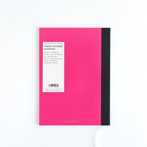 May include: A hot pink notebook with a black spine. The notebook has a white label with black text that reads "CLASSY+MITSU THREAD STITCHING NOTEBOOK". The notebook measures 5.8 x 8.3 inches.