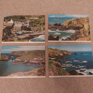 May include: A set of four vintage postcards displaying coastal views. The images show rugged cliffs, the sea, and quaint villages. The postcards capture the scenic beauty of the English coast, with vivid colours and detailed landscapes.