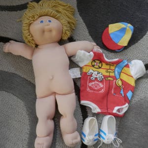 cabbage patch blond girl 1982 yarn hair blue eyes girl with extras 1982 vintage doll full size