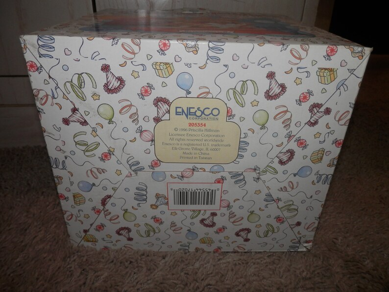 May include: A white box with a colorful party theme design. The box features a barcode, the text "ENESCO CORPORATION", and the number "205354".