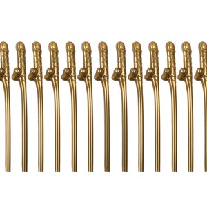 May include: A set of fifteen identical gold-colored drinking straws arranged in a row. Each straw features a molded phallic-shaped decorative element near the top, with a smooth, slender stem extending downward to the base of the straw.