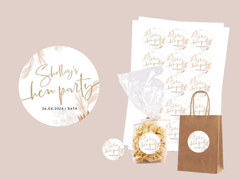 May include: A set of round, white stickers with gold lettering and a floral design. The stickers say "Shelly's hen party 26.04.2024 | BATH".