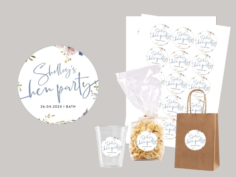 May include: A set of round, white stickers with a floral design and the text "Shelley's hen party 26.04.2024 | BATH" in blue script. The stickers are perfect for decorating party favors or gifts.