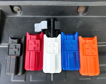 May include: Five different colored plastic cases with a plus sign on the front. The cases are black, red, white, blue, and orange.