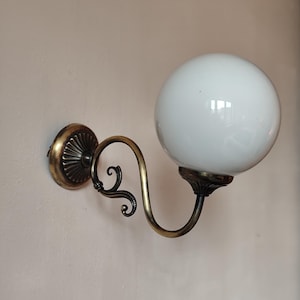 Vintage wall light in brass metal and white opaline globe