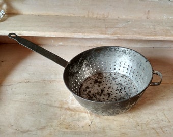 Old iron hand strainer - vintage hole pan