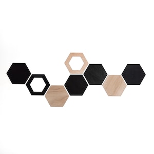 May include: A wall-mounted display set consisting of nine hexagonal pieces arranged in a staggered pattern. The set features a mix of solid black hexagonal panels and natural light wood-toned hexagonal panels, including two open-frame hexagonal borders.