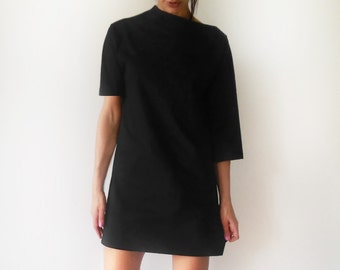 Vestido túnica negro asimétrico: tejido de punto jersey minimalista.
