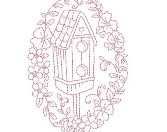 May include: A pink embroidered outline of a birdhouse with a gabled roof and two circular entry holes, positioned on a post. The birdhouse is surrounded by an oval frame of stitched flowers, leaves, and vines on a plain white background.