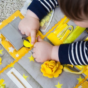 Children play with a blanket. The perfect toy for developing fine motor skills