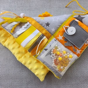 Interesting activities for tactile stimulation: pocket with felt decoration inside, door with snap button. All items are securely attached to each other. twiddle items and felt flowers