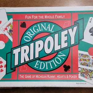 May include: A rectangular board game box for Tripoley Original Edition by Cadaco. The box features a red and green background with illustrations of playing cards, poker chips, and the text Fun for the Whole Family and The Game of Michigan Rummy, Hearts & Poker.