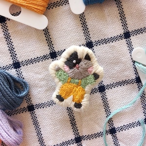 cat wearing yellow pants embroidered patch pin