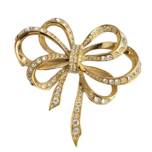 KJL (Kenneth Jay Lane) For Avon Gold Tone Clear Rhinestone Lustrous Bow Brooch, Signed
