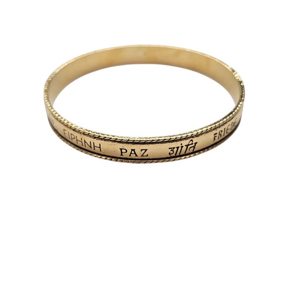 Avon Embossed Peace In Various Languages  Gold Tone Bangle Bracelet J553