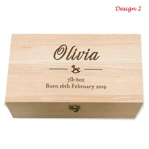 May include: A wooden keepsake box with a personalized inscription. The inscription reads "Olivia 7lb 6oz Born 16th February 2019". The box has a small rocking horse design and a brass latch.