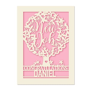 May include: A white card with a pink background featuring a decorative tree with the words "New Job" and the text "Congratulations Daniel".