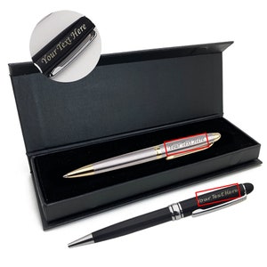 May include: Two silver and black pens with gold accents in a black box. The pens are engraved with the text "Your Text Here".
