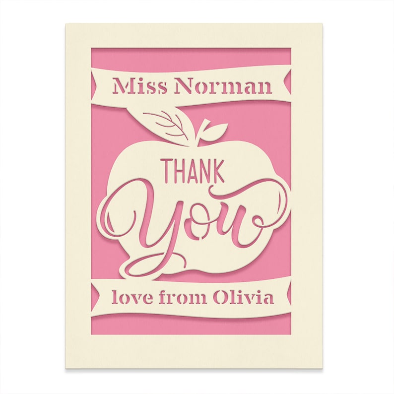 May include: A pink card with a white apple cut out. The apple has the words "Thank You" inside. The card also has the text "Miss Norman" and "love from Olivia" on it.
