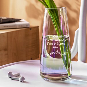 May include: A clear glass vase with a slender, tall design. The vase has a personalized message etched into the glass: "Your Custom Any Message Any Text & Name Here" with a heart and floral design.
